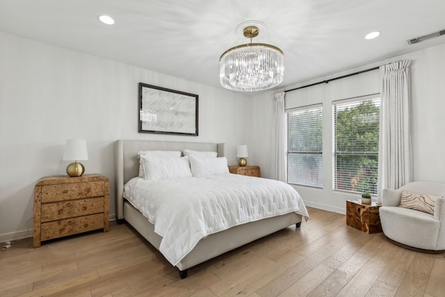 2576 Fountain Cv, Carrollton, TX 75006 - bedroom with a chandelier, light wood finished floors, baseboards, and recessed lighting
