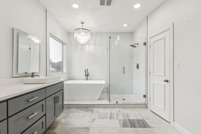 2576 Fountain Cv, Carrollton, TX 75006 - full bath with a stall shower, recessed lighting, vanity, a freestanding tub, and marble look tile flooring