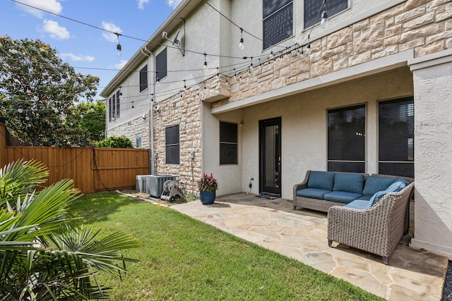 2576 Fountain Cv, Carrollton, TX 75006 - back of property featuring stone siding, a patio area, stucco siding, and an outdoor living space