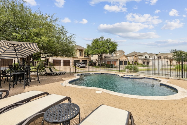 2576 Fountain Cv, Carrollton, TX 75006 - view of swimming pool featuring fence, a residential view, a patio area, and a pool with connected hot tub