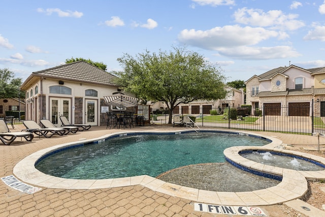 2576 Fountain Cv, Carrollton, TX 75006 - view of pool with fence, a patio area, french doors, and a pool with connected hot tub