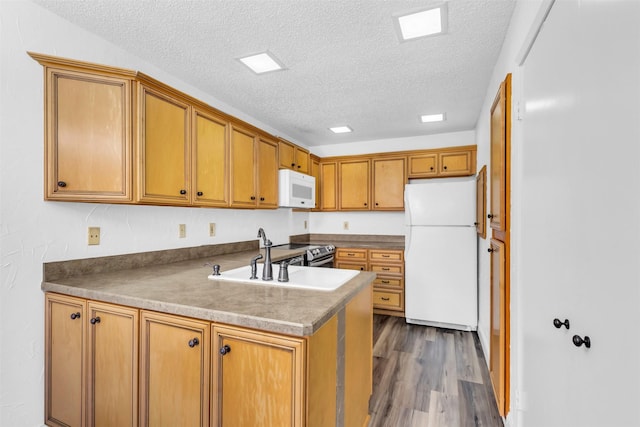 4242 N Capistrano Dr Unit 161, Dallas, TX 75287 - kitchen with white appliances, a sink, a textured ceiling, brown cabinets, and wood finished floors