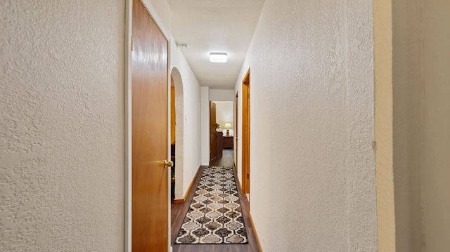 529 Proctor Ave, Waco, TX 76708 - hallway with a textured wall, wood finished floors, and arched walkways