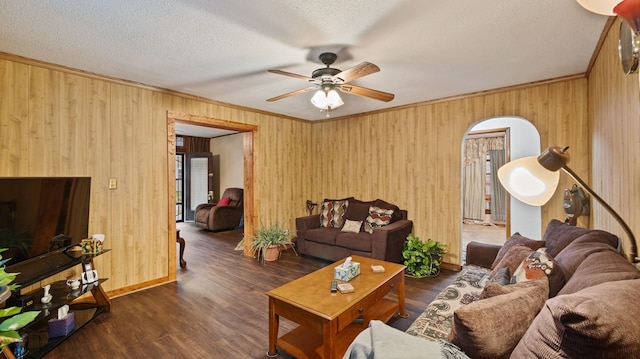 529 Proctor Ave, Waco, TX 76708 - living area featuring a ceiling fan, wood walls, crown molding, arched walkways, and wood finished floors