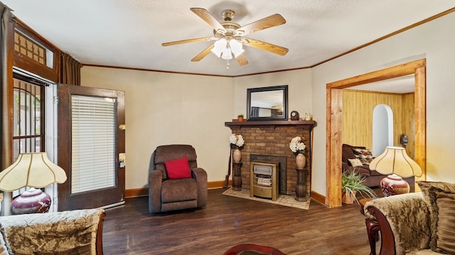 529 Proctor Ave, Waco, TX 76708 - living room featuring a brick fireplace, ceiling fan, wood finished floors, crown molding, and baseboards