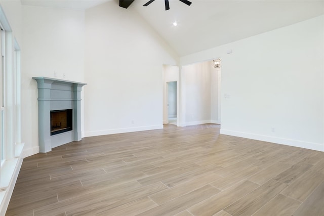316 Falcon Ct, Springtown, TX 76082 - unfurnished living room with ceiling fan, a fireplace, high vaulted ceiling, light wood-style flooring, and baseboards