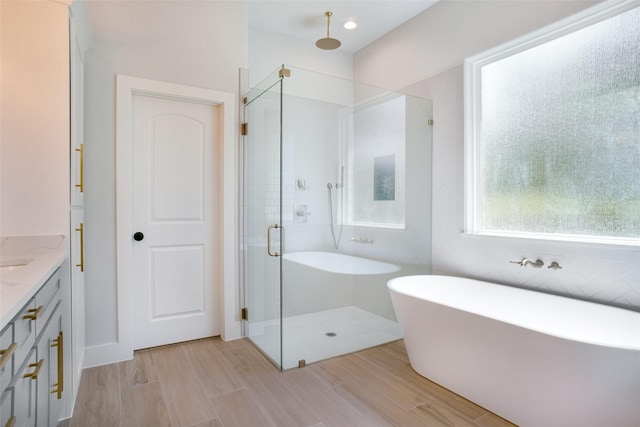 316 Falcon Ct, Springtown, TX 76082 - bathroom with a stall shower, a freestanding tub, vanity, and wood finished floors