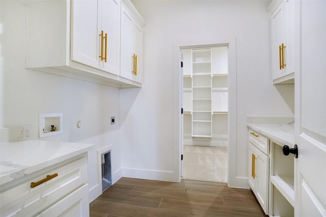 316 Falcon Ct, Springtown, TX 76082 - laundry room with cabinet space, hookup for an electric dryer, dark wood-style flooring, washer hookup, and baseboards