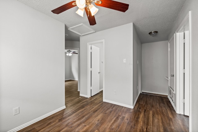2118 W E Roberts Dr, Grand Prairie, TX 75051 - unfurnished bedroom featuring a textured ceiling, wood finished floors, baseboards, a ceiling fan, and attic access