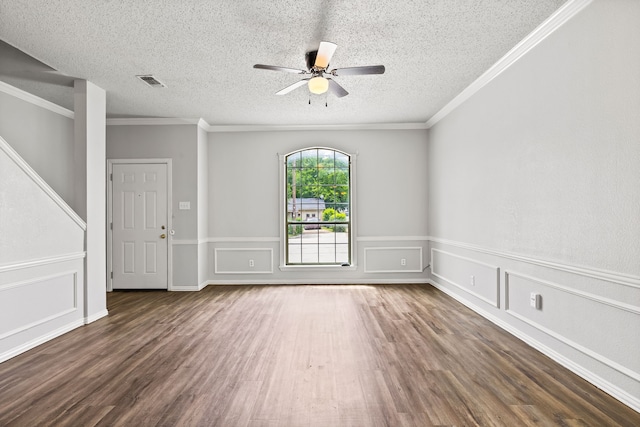 2118 W E Roberts Dr, Grand Prairie, TX 75051 - empty room featuring wood finished floors, ceiling fan, crown molding, a textured ceiling, and a wainscoted wall