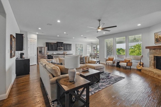 5009 Chisholm View Dr, Fort Worth, TX 76123 - living area featuring ceiling fan, a stone fireplace, dark wood finished floors, baseboards, and recessed lighting