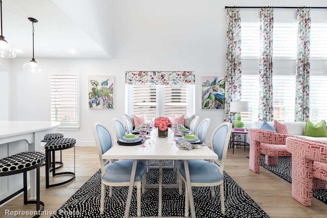 dining area with light wood-style floors, baseboards, and recessed lighting