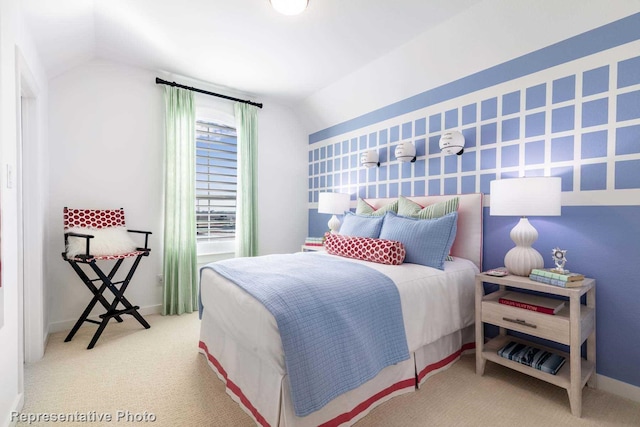 bedroom with vaulted ceiling, carpet floors, and baseboards