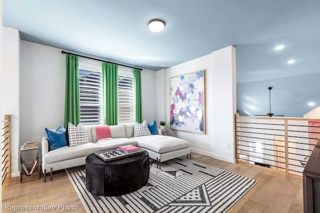 living room featuring wood finished floors, ceiling fan, and baseboards