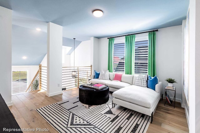 living room featuring light wood-type flooring and baseboards