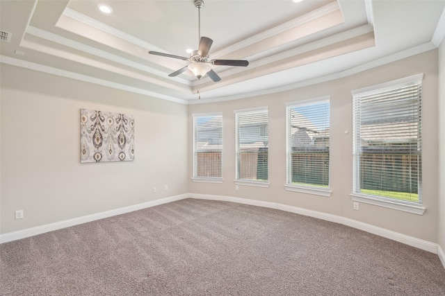 carpeted spare room featuring a raised ceiling, ornamental molding, ceiling fan, baseboards, and recessed lighting