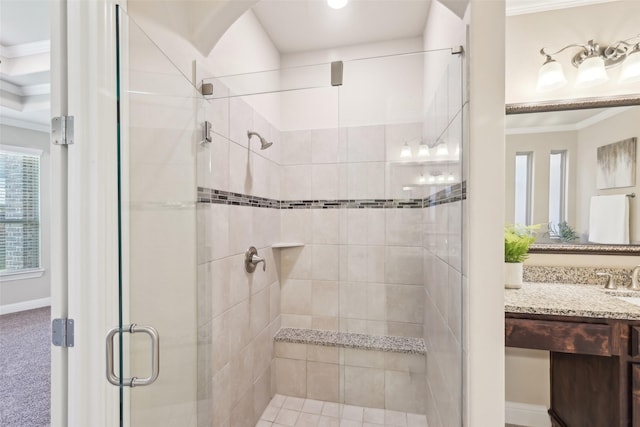 bathroom with ornamental molding, a stall shower, vanity, and baseboards