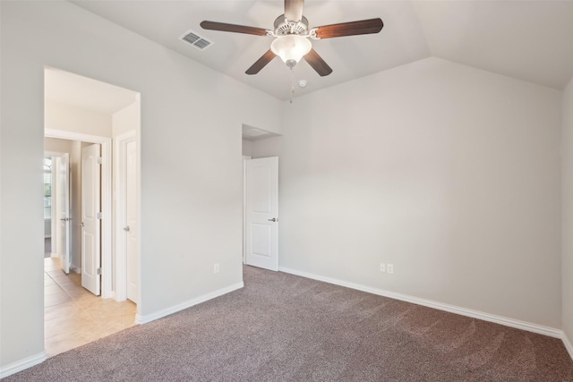 unfurnished bedroom featuring carpet floors, vaulted ceiling, baseboards, and a ceiling fan