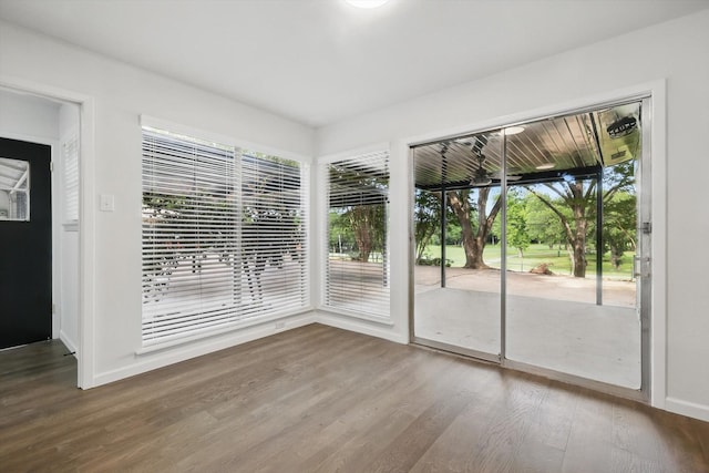 4512 Starlight Dr, Haltom City, TX 76117 - doorway featuring wood finished floors, healthy amount of natural light, and baseboards