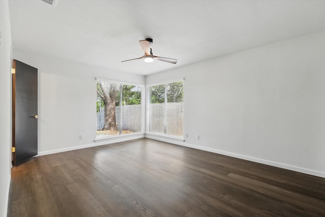 4512 Starlight Dr, Haltom City, TX 76117 - spare room featuring dark wood-style flooring, a ceiling fan, and baseboards