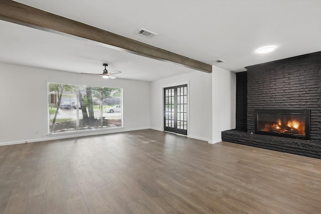4512 Starlight Dr, Haltom City, TX 76117 - unfurnished living room featuring a brick fireplace, dark wood-type flooring, beam ceiling, baseboards, and a ceiling fan