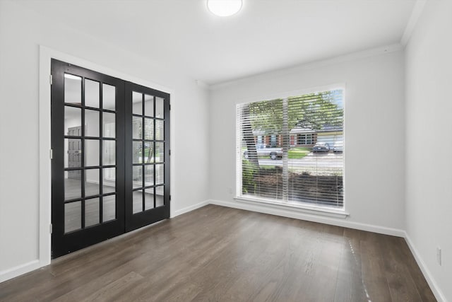 4512 Starlight Dr, Haltom City, TX 76117 - spare room featuring french doors, ornamental molding, dark wood finished floors, and baseboards