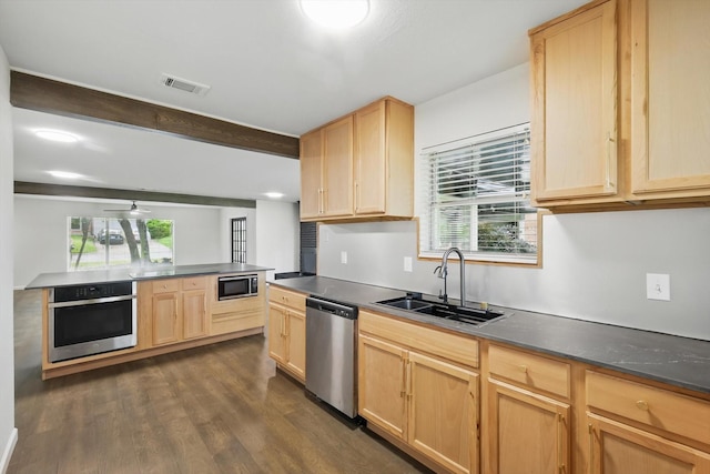 4512 Starlight Dr, Haltom City, TX 76117 - kitchen with stainless steel appliances, light brown cabinets, a sink, dark countertops, and beam ceiling