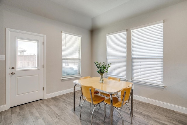 dining space with light wood-style floors and baseboards