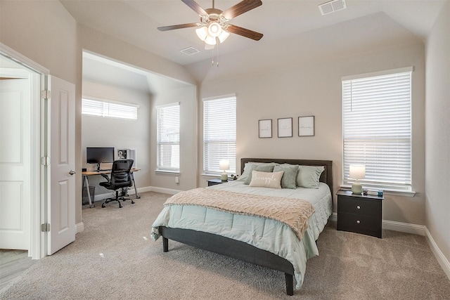 bedroom with a desk, light colored carpet, baseboards, and vaulted ceiling