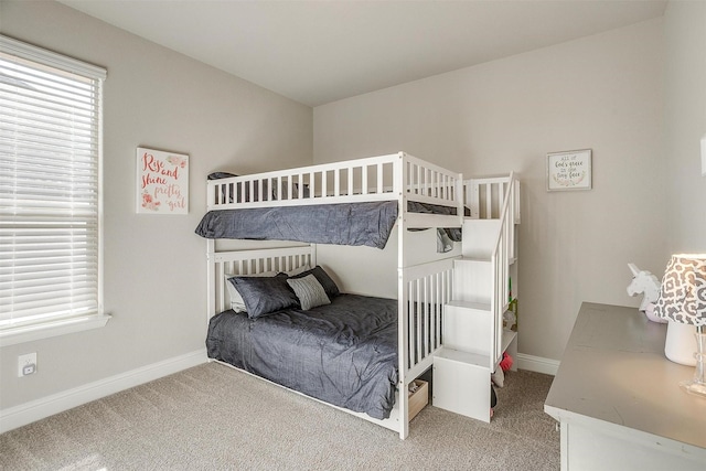 carpeted bedroom featuring baseboards