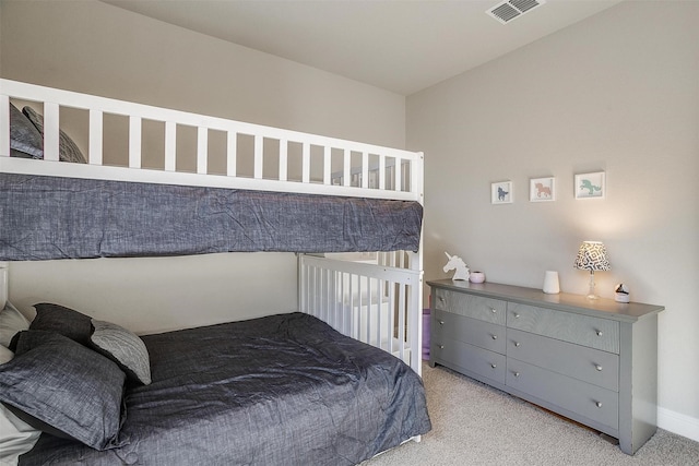 bedroom with light colored carpet and baseboards