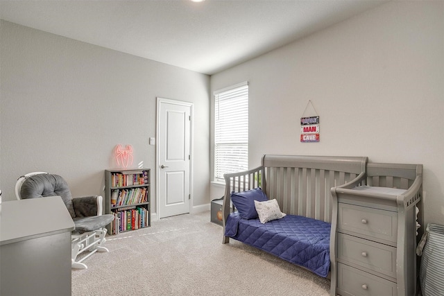 carpeted bedroom featuring baseboards