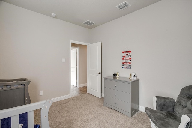 bedroom with light carpet and baseboards