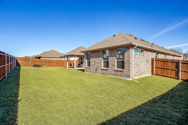 rear view of house featuring roof with shingles and brick siding