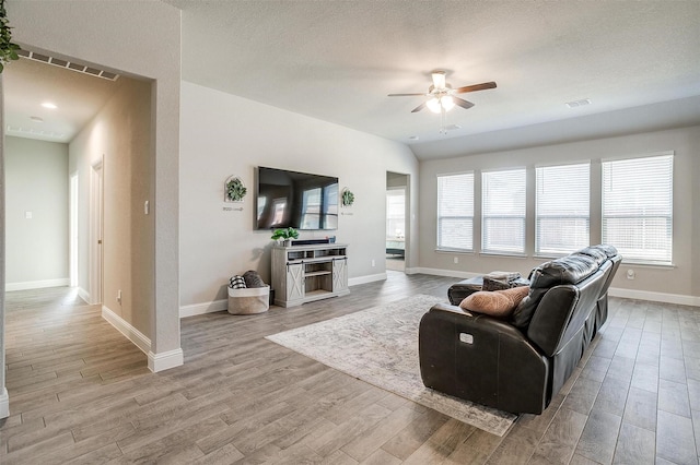 living area featuring a ceiling fan, wood finished floors, and baseboards