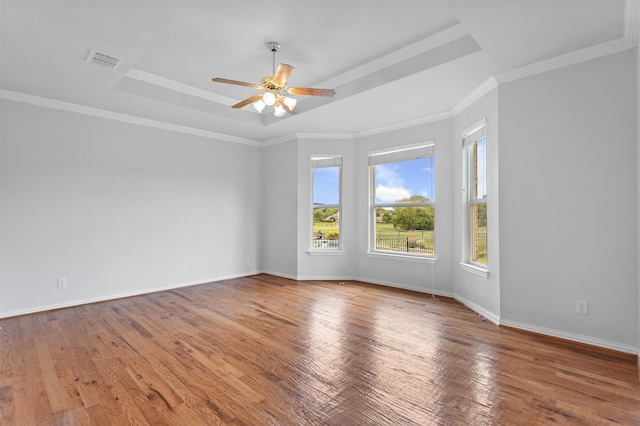 2701 Royal Troon Dr, Plano, TX 75025 - spare room featuring a tray ceiling, wood finished floors, a ceiling fan, baseboards, and crown molding