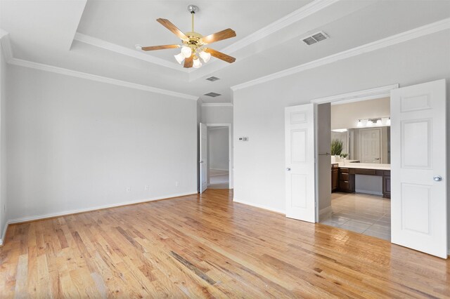 2701 Royal Troon Dr, Plano, TX 75025 - unfurnished bedroom featuring a raised ceiling, light wood-style floors, ornamental molding, baseboards, and ensuite bath