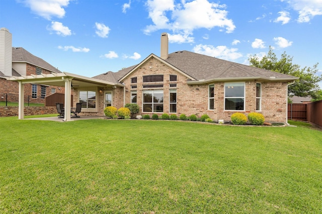 2701 Royal Troon Dr, Plano, TX 75025 - back of property with a patio, a chimney, brick siding, and roof with shingles