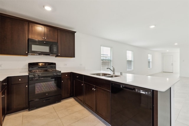7709 Lindheimer Ln, Mckinney, TX 75071 - kitchen featuring black appliances, a sink, a peninsula, light tile patterned floors, and light countertops