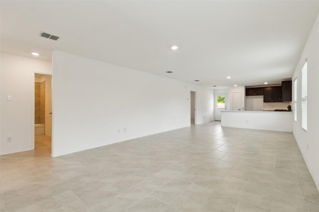 7709 Lindheimer Ln, Mckinney, TX 75071 - unfurnished living room featuring plenty of natural light, recessed lighting, and light tile patterned floors