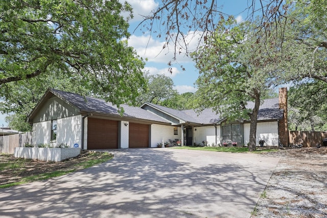 3206 S Fm 51, Decatur, TX 76234 - view of front of home with a garage, brick siding, fence, and concrete driveway