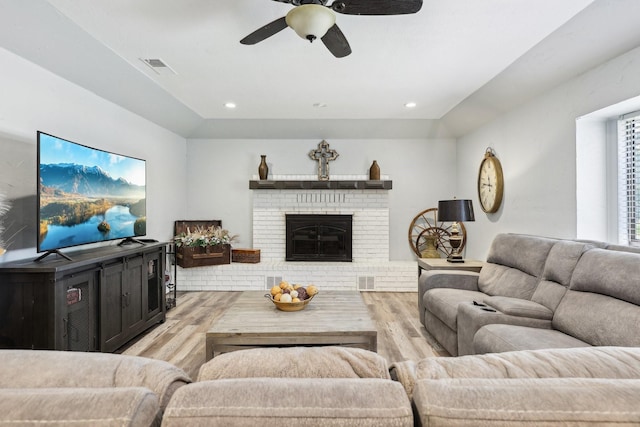 3206 S Fm 51, Decatur, TX 76234 - living area with wood finished floors, a ceiling fan, a brick fireplace, and recessed lighting