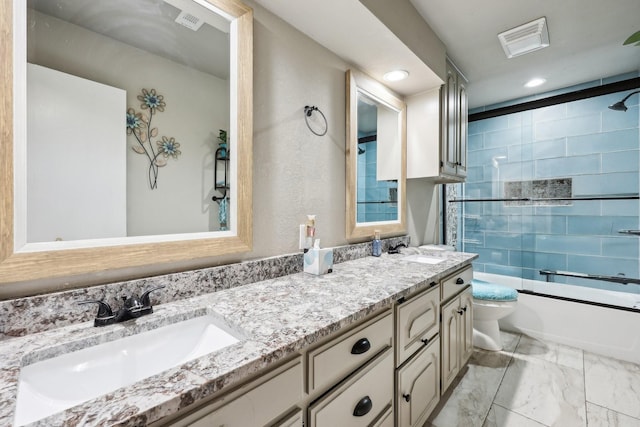 3206 S Fm 51, Decatur, TX 76234 - bathroom featuring toilet, marble look tile flooring, enclosed tub / shower combo, double vanity, and recessed lighting