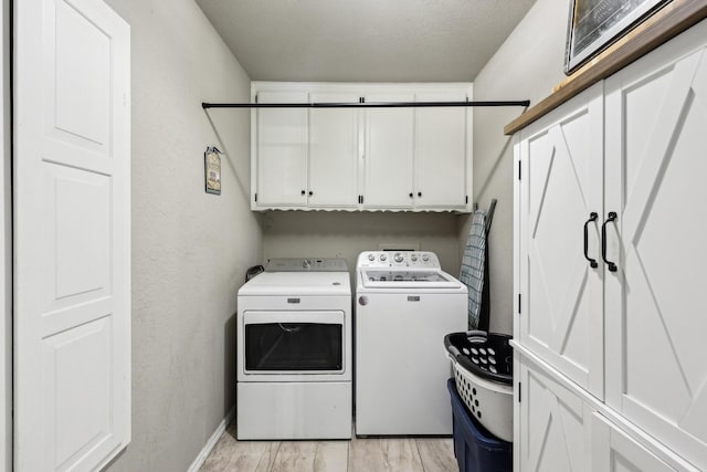 3206 S Fm 51, Decatur, TX 76234 - laundry room featuring cabinet space, washing machine and clothes dryer, light wood finished floors, a textured ceiling, and baseboards