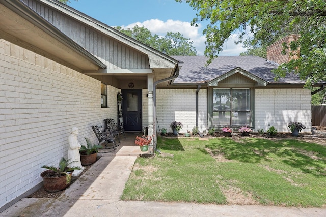 3206 S Fm 51, Decatur, TX 76234 - doorway to property featuring brick siding, a yard, a shingled roof, and a chimney