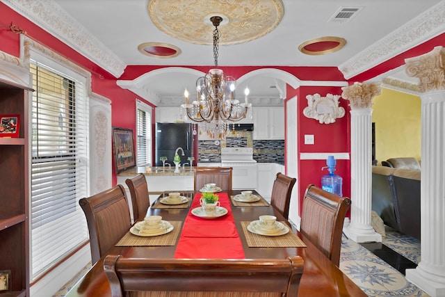 10227 Oak Gate Ln, Dallas, TX 75217 - dining space with ornate columns, a chandelier, ornamental molding, and arched walkways