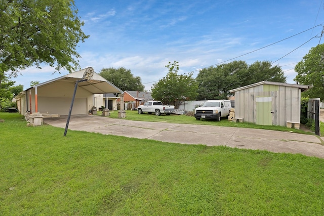 10227 Oak Gate Ln, Dallas, TX 75217 - view of green lawn featuring an outdoor structure, a garage, driveway, and a storage unit