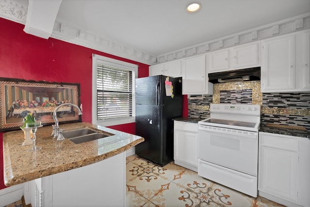 10227 Oak Gate Ln, Dallas, TX 75217 - kitchen featuring electric stove, under cabinet range hood, freestanding refrigerator, a sink, and white cabinetry