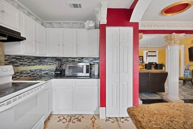 10227 Oak Gate Ln, Dallas, TX 75217 - kitchen featuring white electric range, stainless steel microwave, white cabinets, under cabinet range hood, and decorative columns