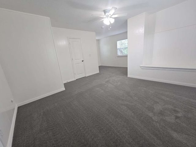 211 Hickory Ln, Weatherford, TX 76086 - empty room featuring a ceiling fan, dark colored carpet, and baseboards